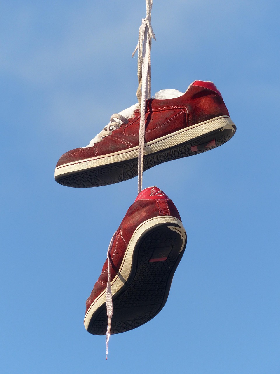 A pair of trainers hanging from a rope